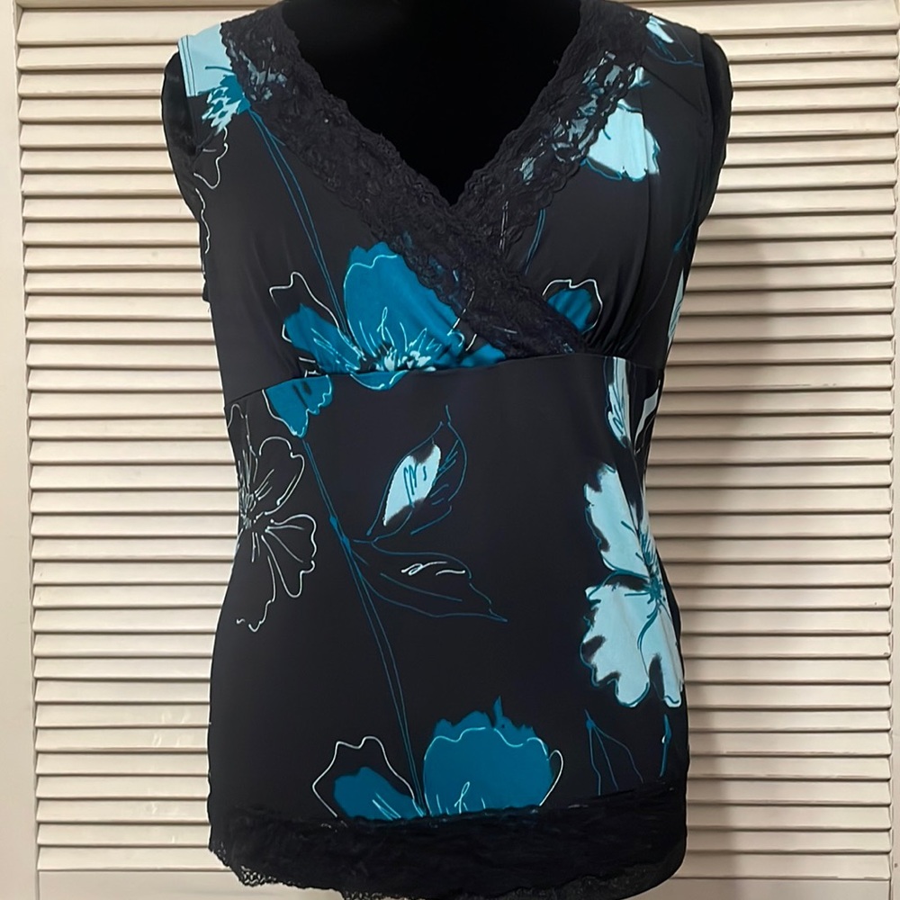 Turquoise and black top with lace neckline.